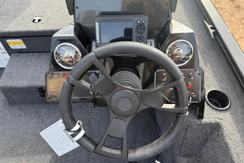 Slide: The Image of 2026 Lowe Stinger 195 Bass boat dashboard with steering wheel and control panel. - 9