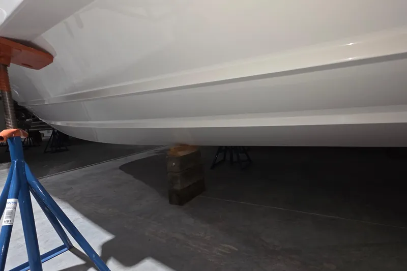 Slide: The Image of 2023 Tiara Sport 34LX boat hull with sleek design and blue accents. - 10