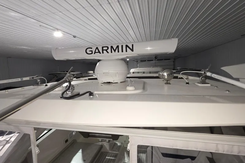 Slide: The Image of 2023 Tiara Sport 34LX boat hull in storage, showcasing sleek design and blue finish. - 12