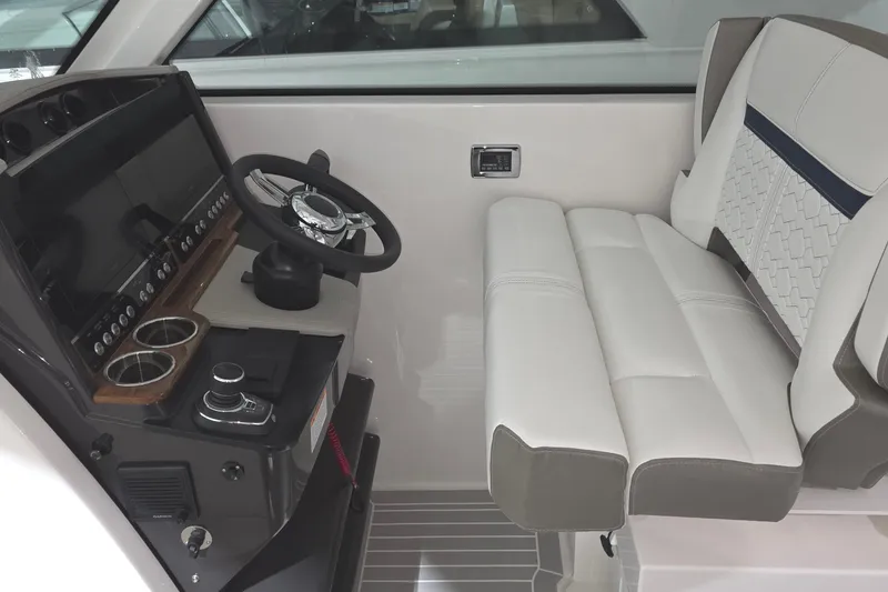 Slide: The Image of 2023 Tiara Sport 34LX boat in storage, side view with blue hull. - 13