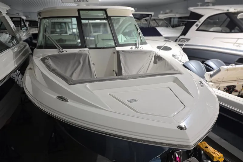 Slide: The Image of 2023 Tiara Sport 34LX boat in storage, blue hull, indoor facility. - 3