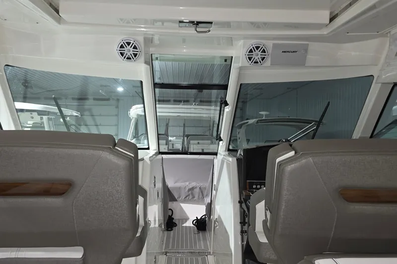 Slide: The Image of 2023 Tiara Sport 34LX boat interior with wooden table and seating area. - 30