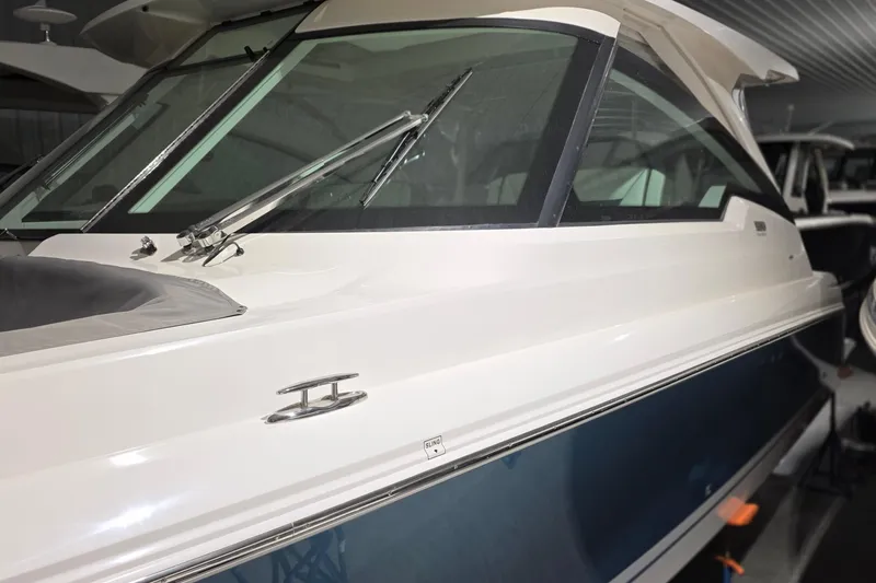 Slide: The Image of 2023 Tiara Sport 34LX boat with dual Mercury 400 engines in a showroom. - 4