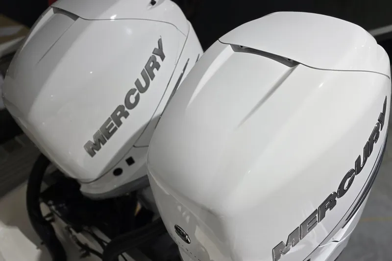 Slide: The Image of 2023 Tiara Sport 34LX boat with dual Mercury Verado 400 outboard engines displayed indoors. - 60