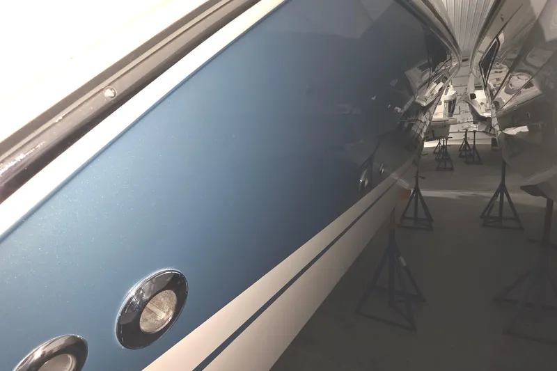 Slide: The Image of 2023 Tiara Sport 34LX boat in storage, featuring sleek design and Garmin equipment. - 7