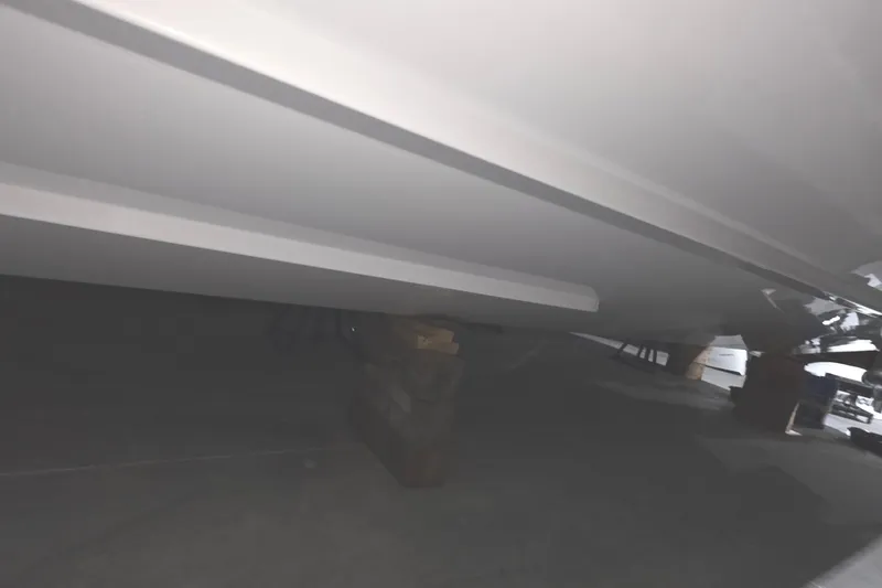 Slide: The Image of 2023 Tiara Sport 34LX boat in showroom, front view. - 9