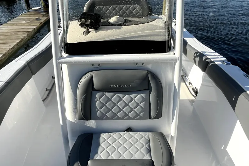 Slide: The Image of 2024 NauticStar 222L Offshore boat interior with gray quilted seats. - 6