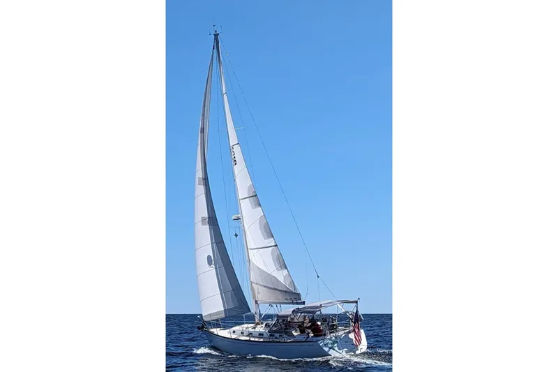 Slide: The Image of Sailing Tartan 3700 Sloop, 2001 model, gliding on open sea under clear blue sky. - 1
