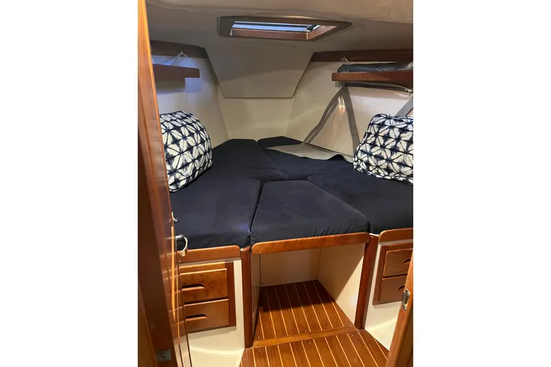 Slide: The Image of Cozy cabin interior of 2001 Tartan 3700 Sloop with plush bedding and wooden accents. - 7