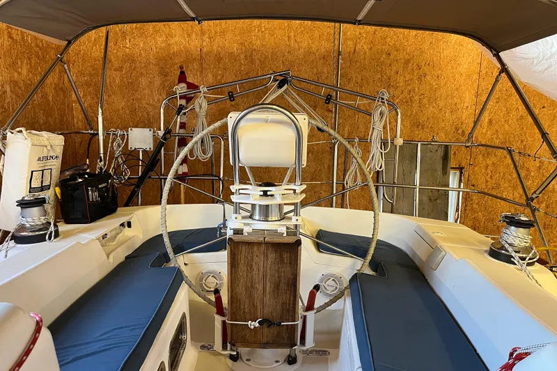 Slide: The Image of Interior view of a 2001 Tartan 3700 Sloop sailboat, showcasing the cockpit and seating area. - 14