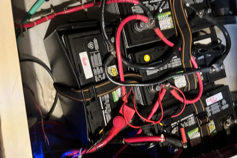 Slide: The Image of Battery compartment of a 2001 Tartan 3700 Sloop with connected cables. - 18