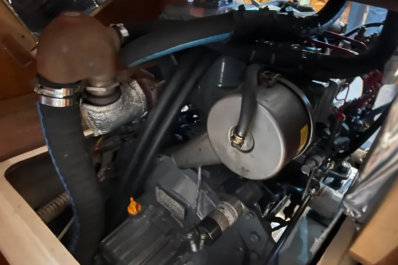 Slide: The Image of Engine compartment of a 2001 Tartan 3700 Sloop sailboat, showcasing mechanical components. - 19