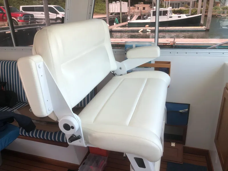 Slide: The Image of White leather captain's chair on 2003 Wesmac Flybridge boat interior. - 11