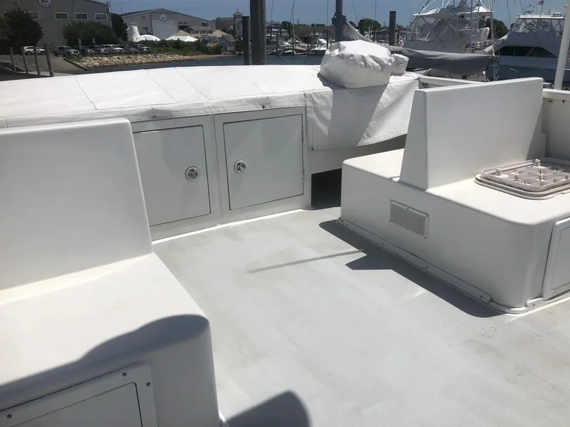 Slide: The Image of 2003 Wesmac Flybridge boat deck with seating and storage compartments. - 16