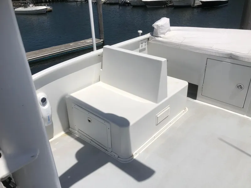Slide: The Image of 2003 Wesmac Flybridge boat deck with seating and storage, docked at marina. - 25