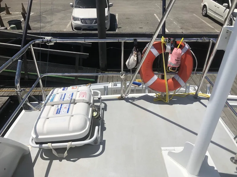 Slide: The Image of 2003 Wesmac Flybridge deck with life preserver and safety equipment. - 27