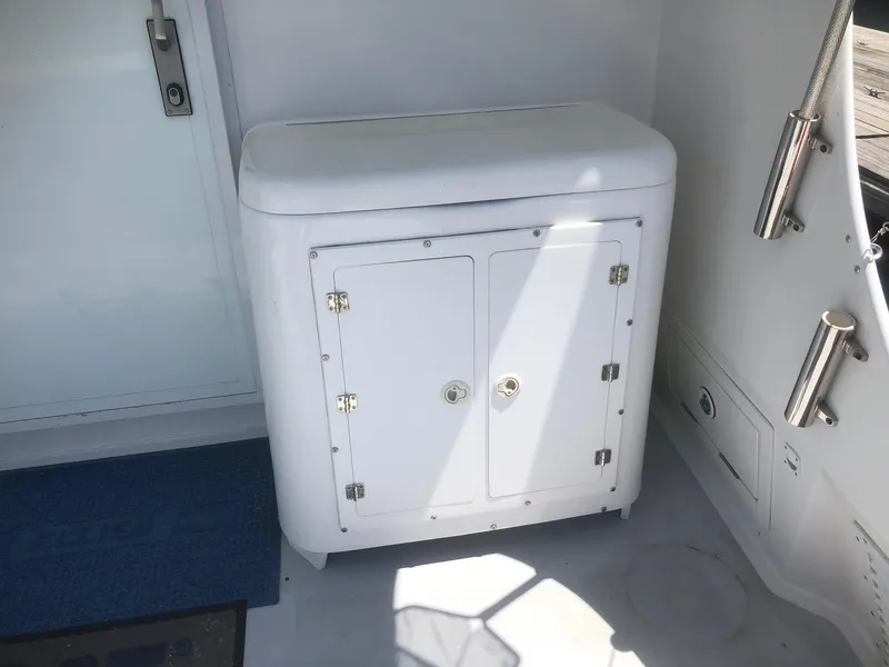 Slide: The Image of White storage cabinet on 2003 Wesmac Flybridge boat deck. - 32