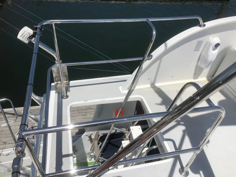 Slide: The Image of 2003 Wesmac Flybridge boat with stainless steel railings and open hatch. - 34