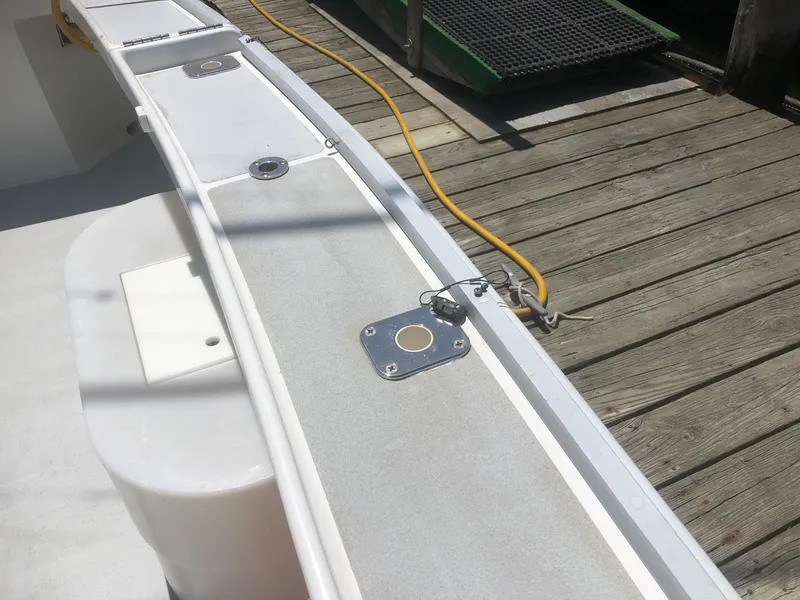 Slide: The Image of 2003 Wesmac Flybridge boat deck with dock and power cable. - 37
