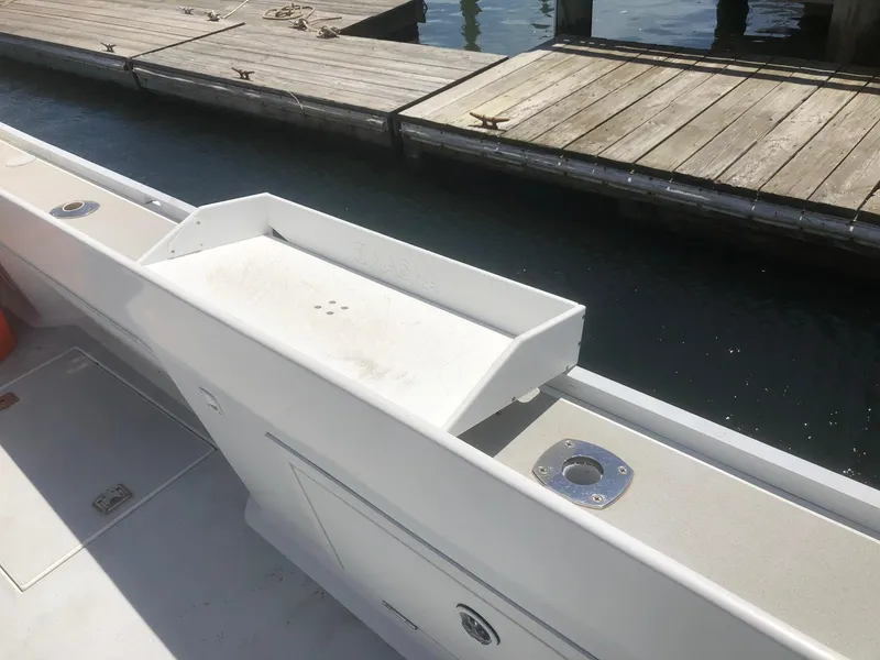 Slide: The Image of 2003 Wesmac Flybridge boat deck near wooden dock. - 38