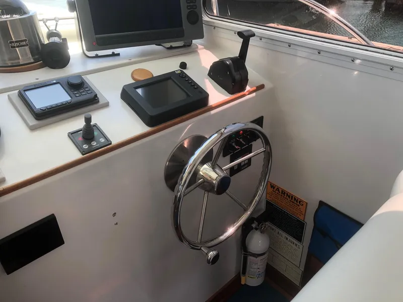 Slide: The Image of 2003 Wesmac Flybridge helm with navigation equipment and steering wheel. - 39