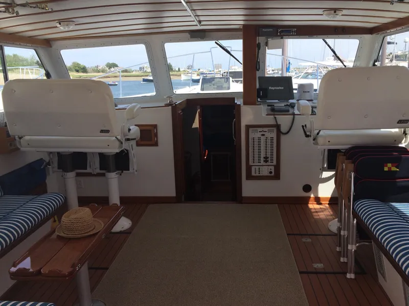 Slide: The Image of Interior of 2003 Wesmac Flybridge boat with seating and navigation equipment. - 42