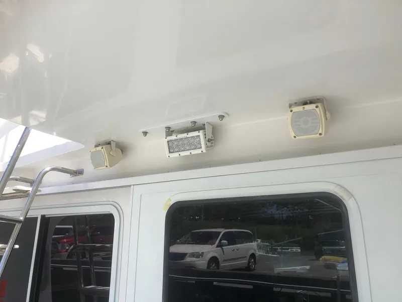 Slide: The Image of 2003 Wesmac Flybridge with exterior speakers and ladder detail. - 43