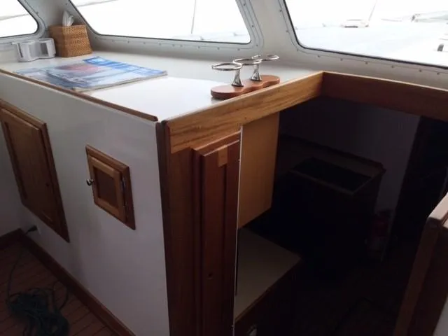 Slide: The Image of Interior of 2003 Wesmac Flybridge boat with wooden cabinetry and nautical decor. - 46