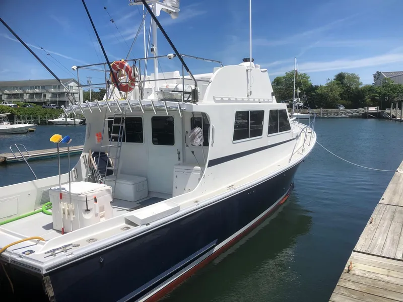 Slide: The Image of 2003 Wesmac Flybridge boat docked in a marina under clear blue skies. - 5