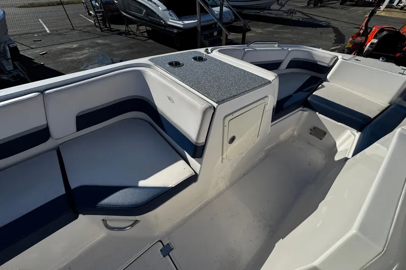 Slide: The Image of 2019 Chaparral 191 Suncoast boat interior with seating and storage compartments. - 12