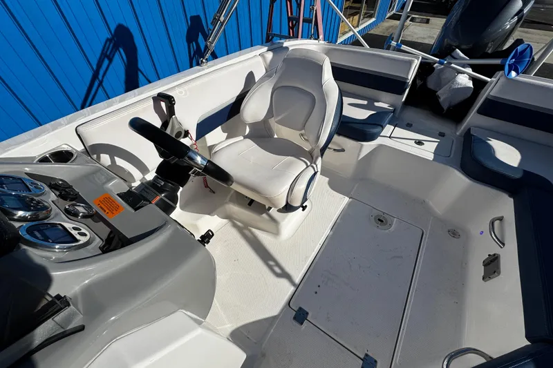 Slide: The Image of 2019 Chaparral 191 Suncoast boat interior with steering wheel and seating. - 15