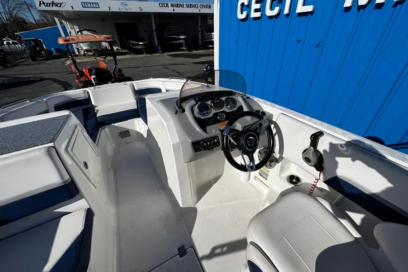 Slide: The Image of 2019 Chaparral 191 Suncoast boat interior with steering wheel and dashboard at service center. - 19