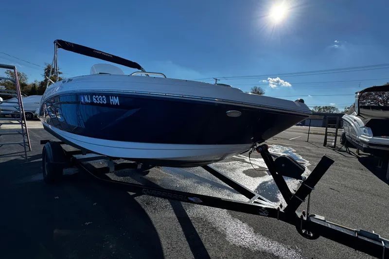 Slide: The Image of 2019 Chaparral 191 Suncoast boat on trailer under bright sun. - 2
