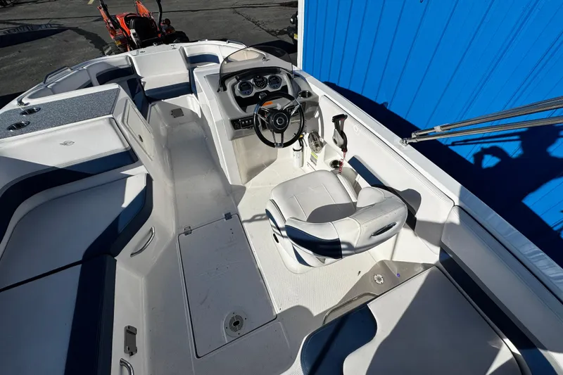 Slide: The Image of 2019 Chaparral 191 Suncoast boat interior with steering wheel and seating. - 20