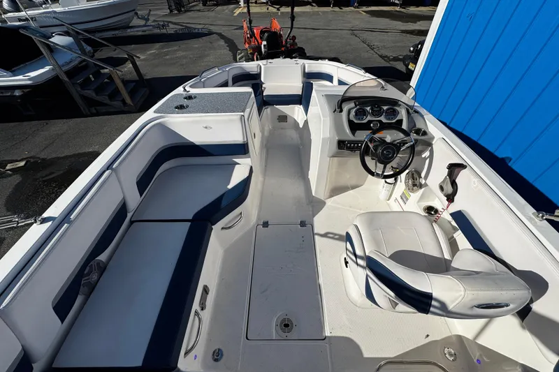 Slide: The Image of 2019 Chaparral 191 Suncoast boat interior with seating and steering console. - 21