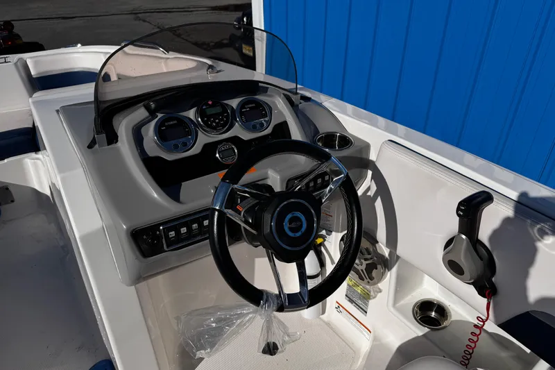 Slide: The Image of 2019 Chaparral 191 Suncoast boat dashboard with steering wheel and controls. - 6