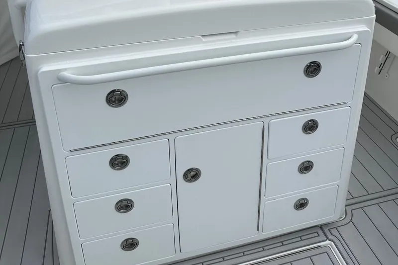 Slide: The Image of 2023 Regulator 34 boat storage compartment with multiple drawers and sleek design. - 16