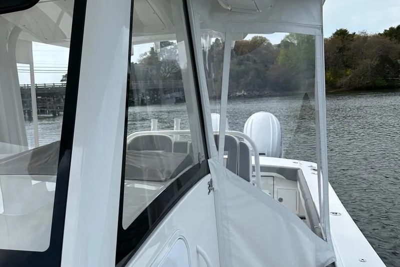 Slide: The Image of 2023 Regulator 34 boat on calm water, featuring sleek design and clear enclosure. - 20