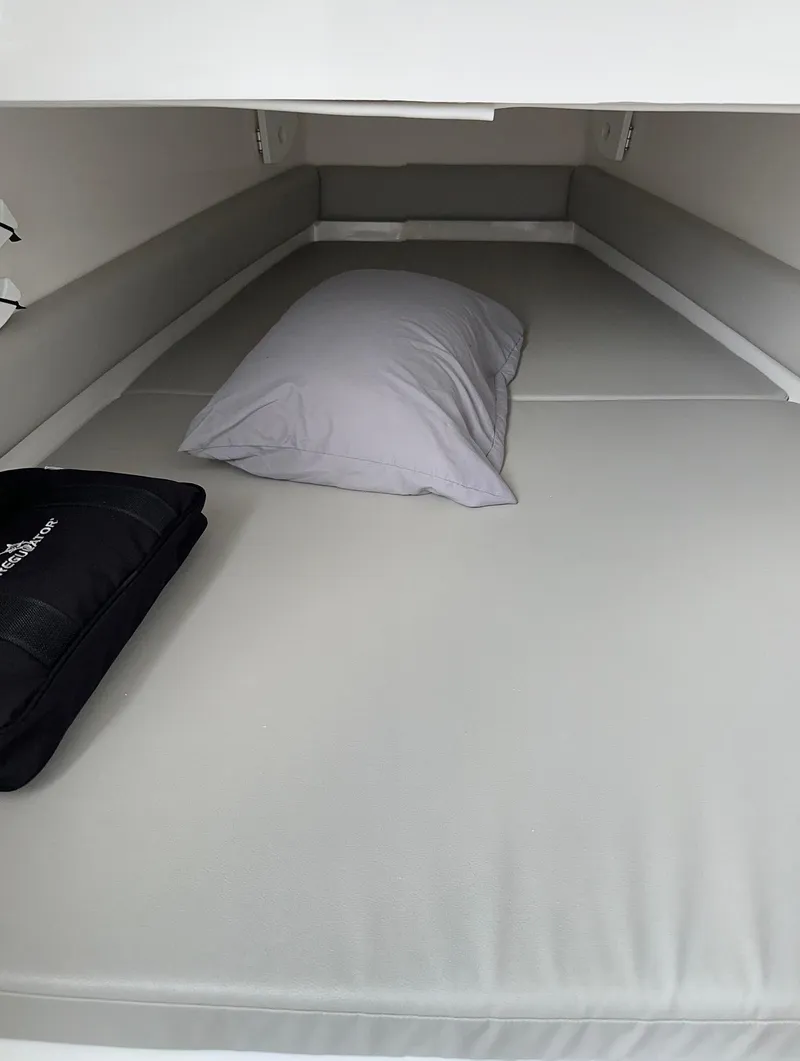 Slide: The Image of 2023 Regulator 34 cabin interior with bed and pillow, showcasing comfortable sleeping area. - 21