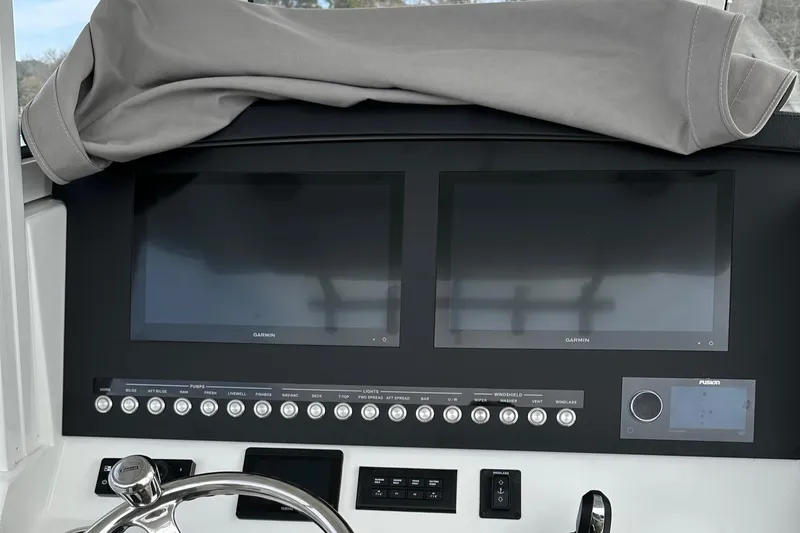 Slide: The Image of 2023 Regulator 34 boat dashboard with dual screens and control panel. - 22