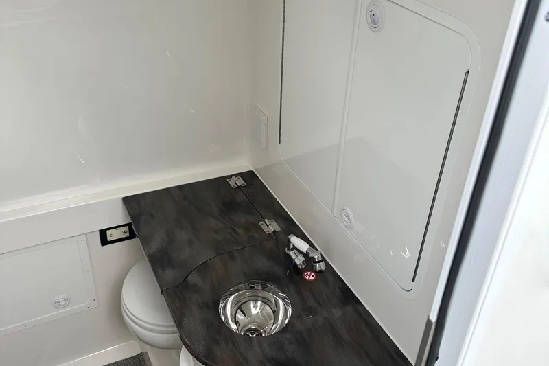 Slide: The Image of 2023 Regulator 34 boat interior with sink and toilet. - 24