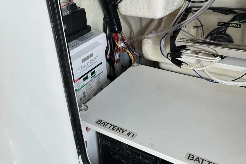 Slide: The Image of 2023 Regulator 34 boat battery compartment with wiring and ProMariner charger. - 25
