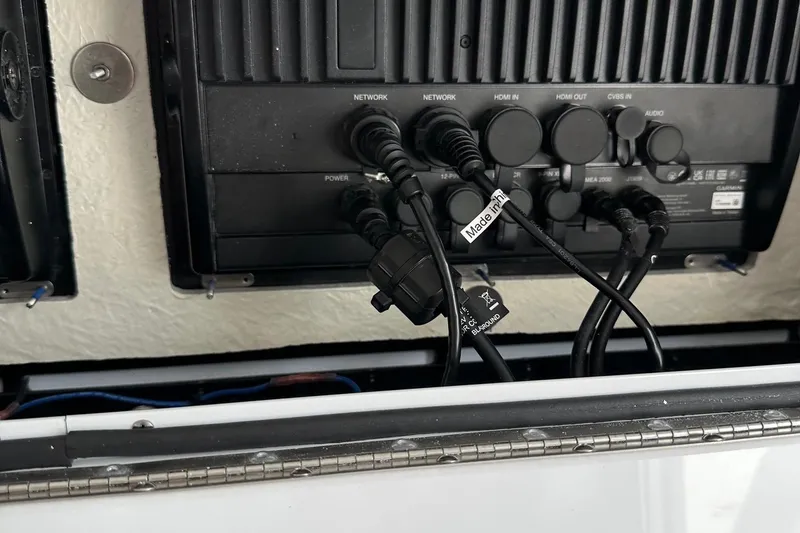 Slide: The Image of 2023 Regulator 34 boat electronics panel with network and power cables connected. - 27