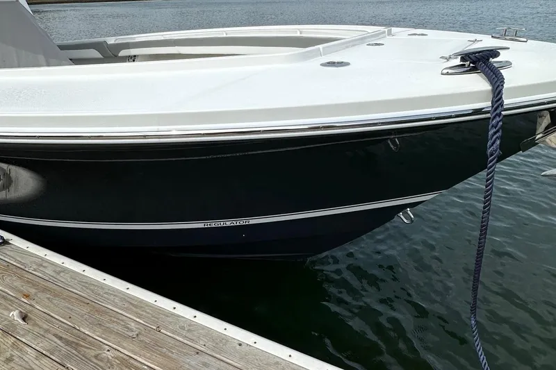 Slide: The Image of 2023 Regulator 34 boat docked, featuring sleek design and modern build. - 3