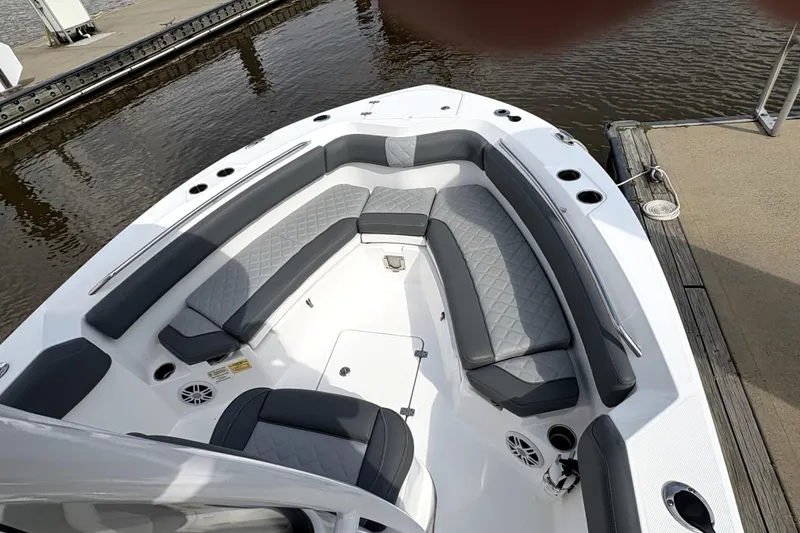 Slide: The Image of 2024 NauticStar 222L Offshore boat with spacious seating and modern design at a dock. - 8