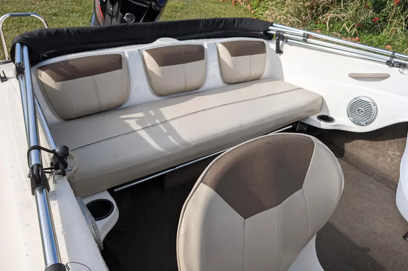 Slide: The Image of 2016 Bayliner 160 Bowrider interior with beige seating and speaker system. - 4