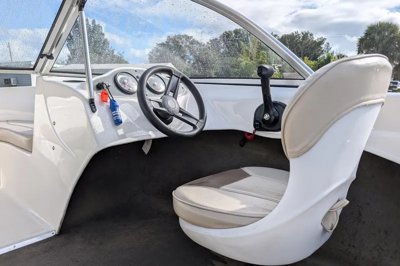 Slide: The Image of 2016 Bayliner 160 Bowrider interior with steering wheel and control panel. - 6