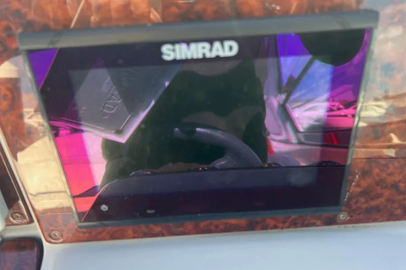 Slide: The Image of Simrad navigation system on a 2005 Formula 330 Sun Sport boat dashboard. - 12