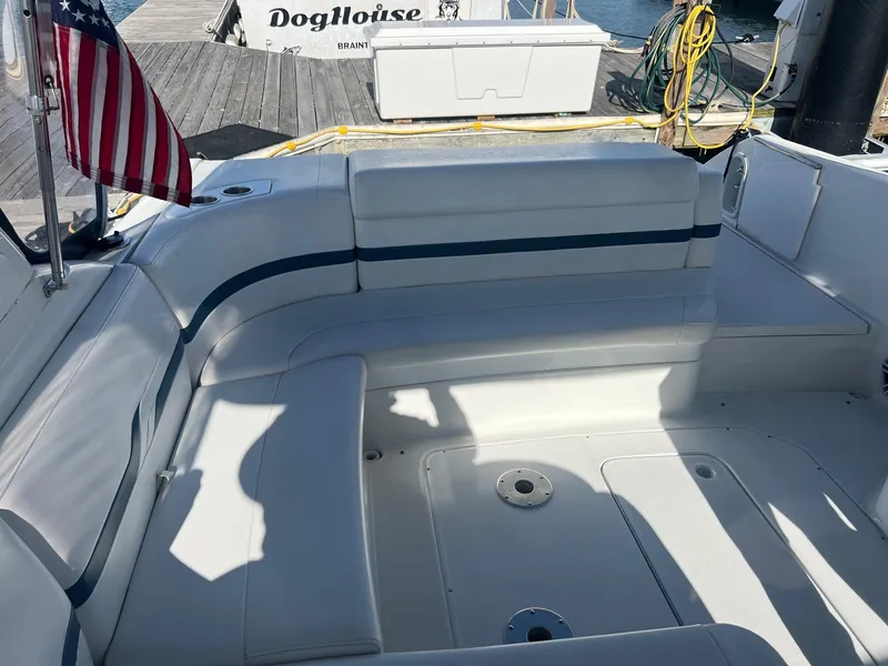 Slide: The Image of 2005 Formula 330 Sun Sport boat with spacious seating area and American flag. - 15