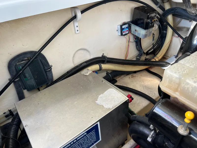 Slide: The Image of Engine compartment of a 2005 Formula 330 Sun Sport boat showing various components and wiring. - 18